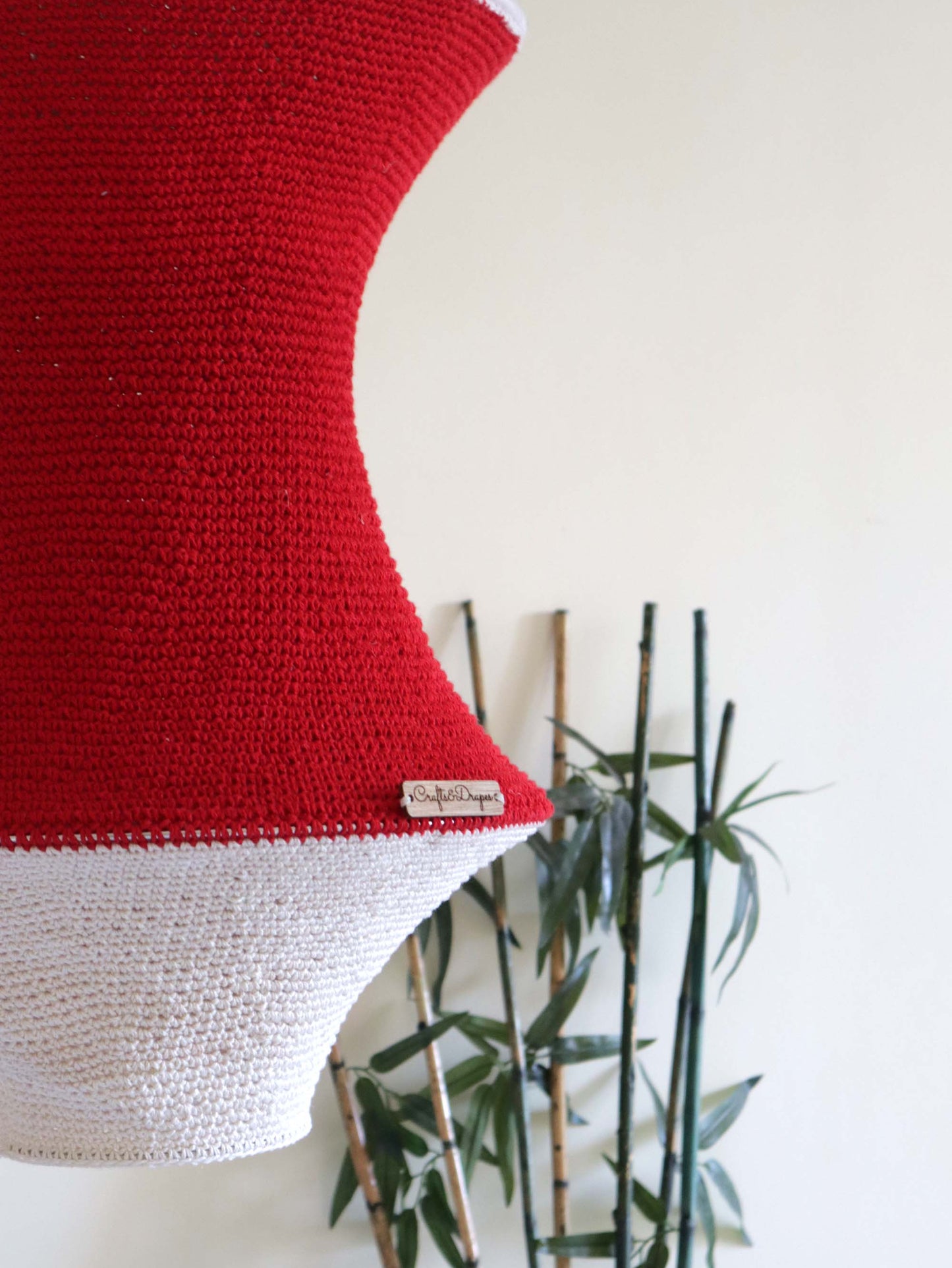 "Artisan-made handwoven red and ivory crochet light.